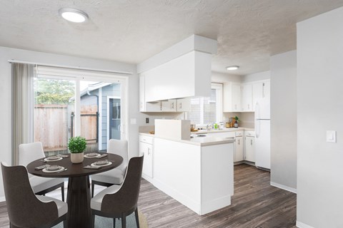 an open kitchen and dining room with a table and chairs